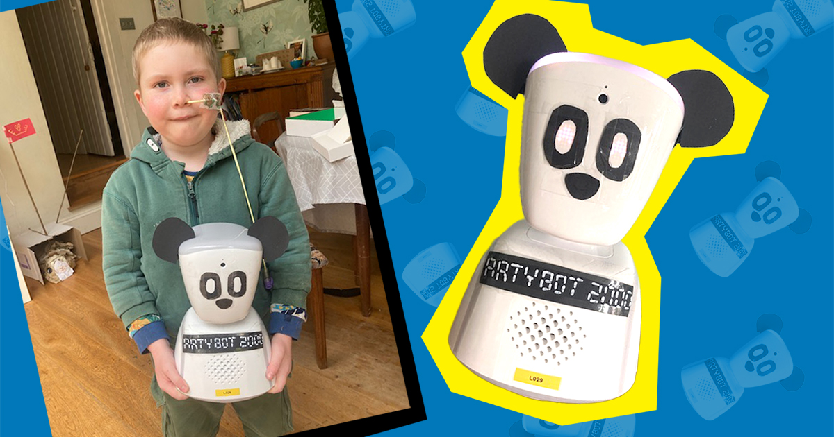 Boy holding small robot decorated as a panda