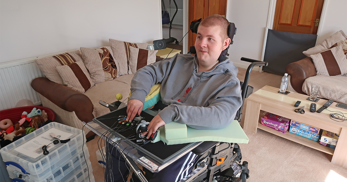 Young man in wheelchair using an adapted gaming setup