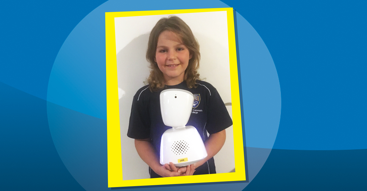 Smiling girl holding a small desktop robot