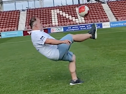 Man midway through overhead kick